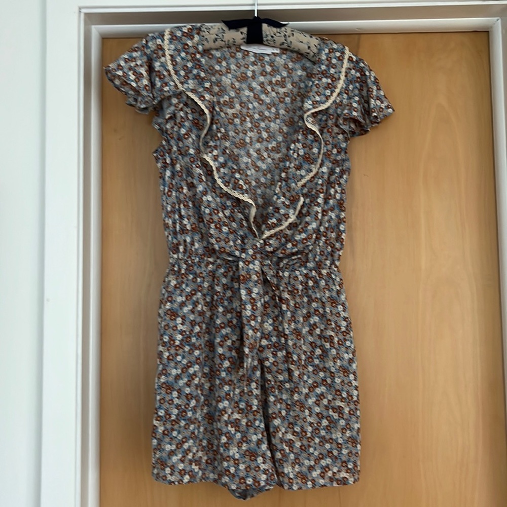 V-neck, floral print romper with lace detail, and pockets!